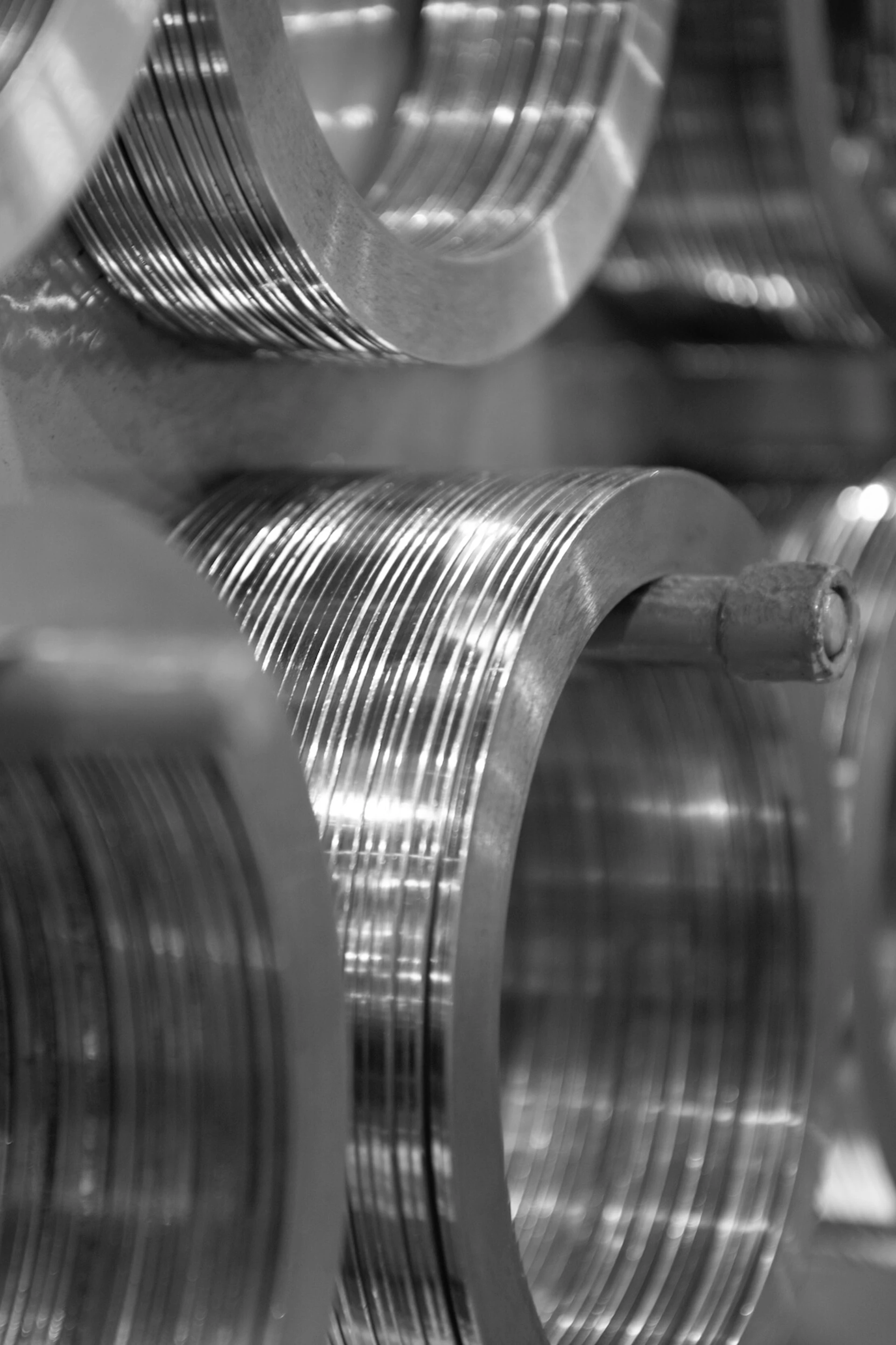 Close up of multiple smaller coils of steel, displayed on a rack